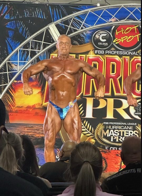 Coach Nick Meshew posing on stage at the 2026 Hurricane Pro